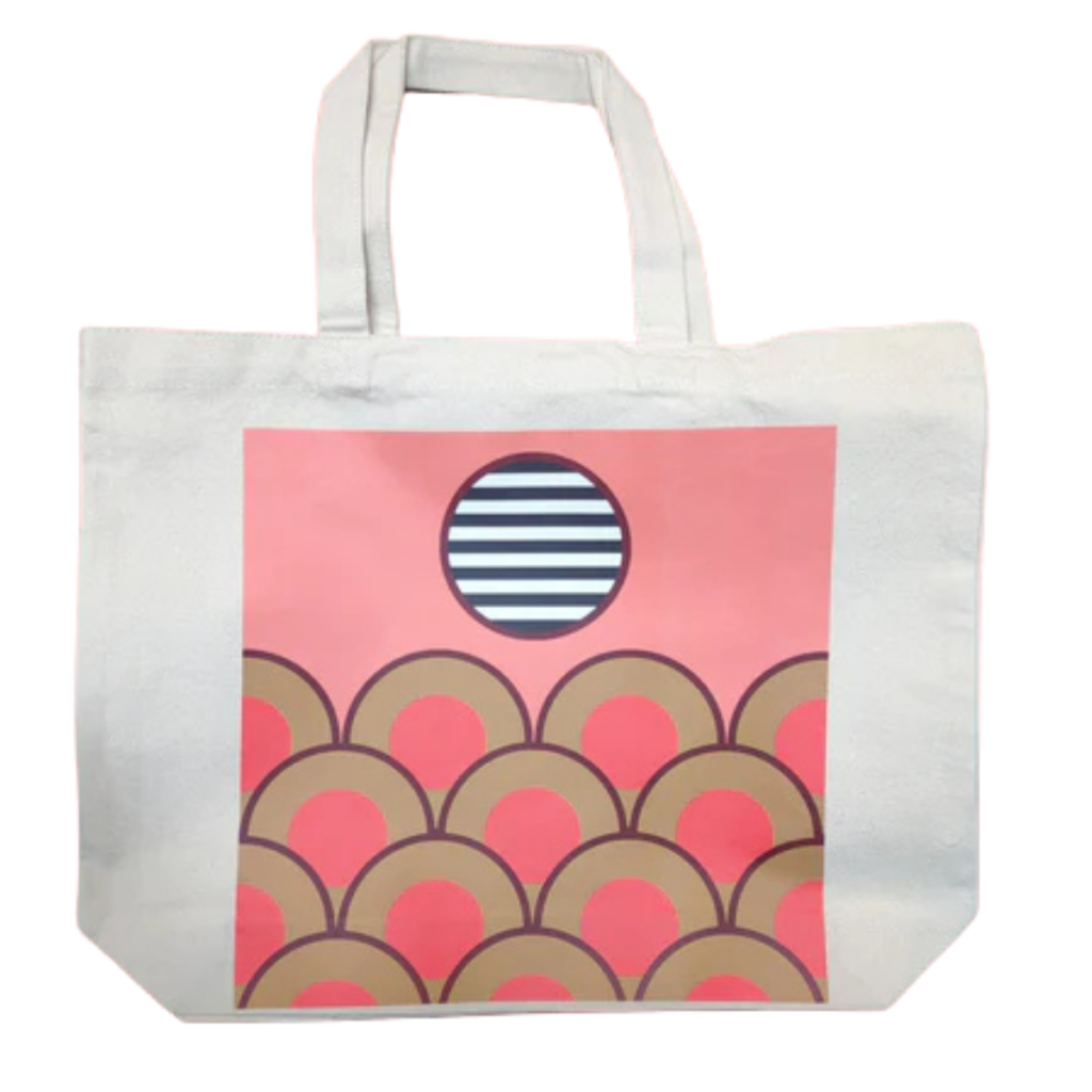 Natural canvas tote bag with a soft pink background and abstract design of scalloped arches beneath a striped sun motif.