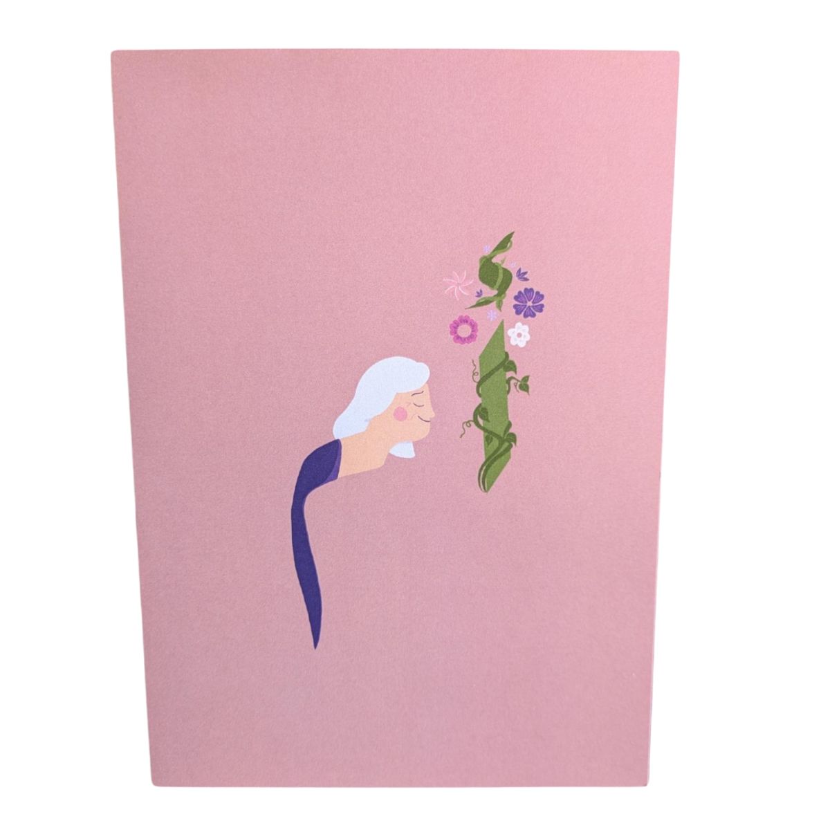 A tender design by Jasmine Hawamdeh that honors the beauty and strength of motherhood in full bloom. Illustrated greeting card with a minimalist drawing of an older woman in profile, facing a tall flowering vine on a soft pink background.